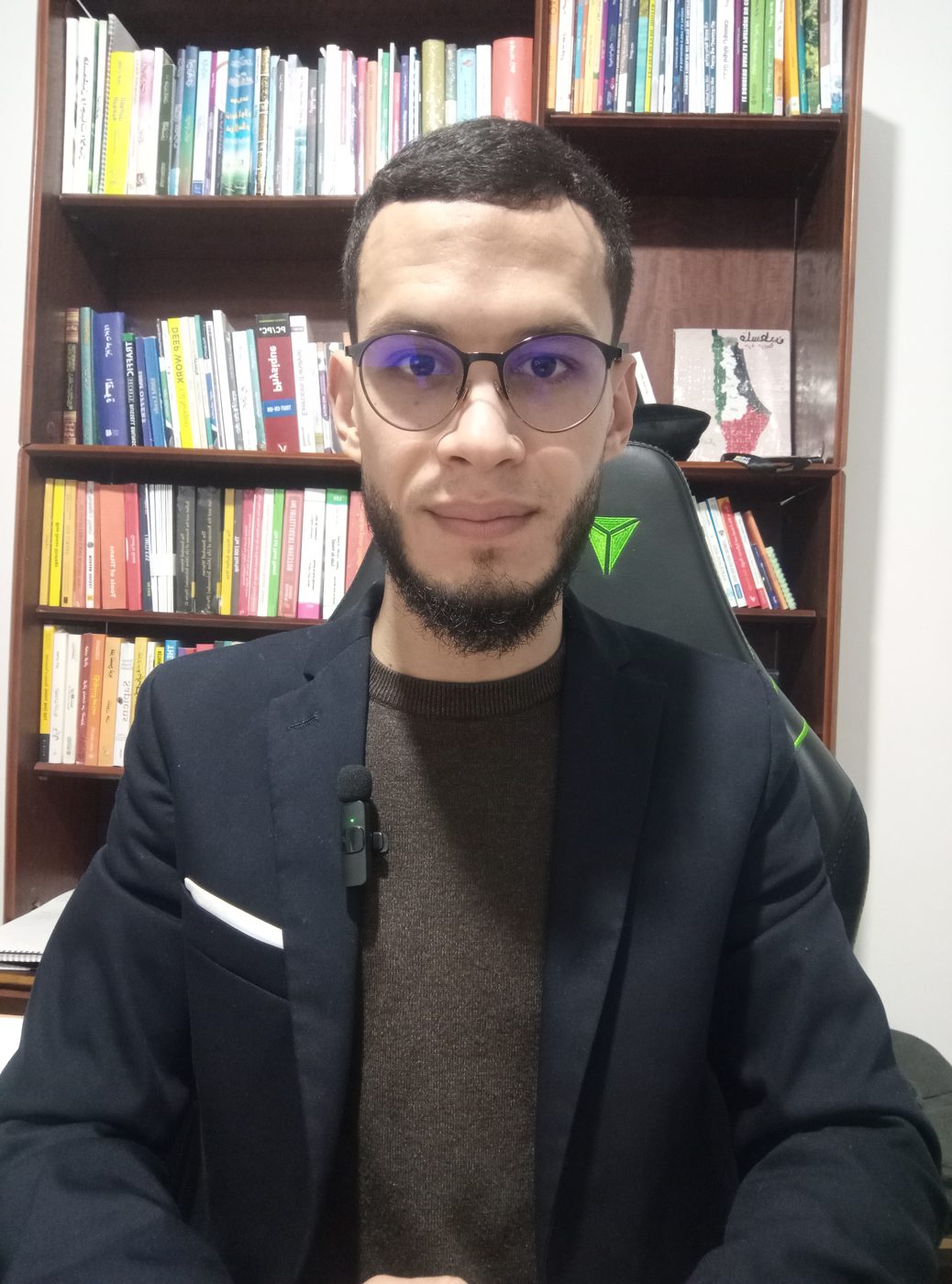 Youness ES-SEBIY in front of his library